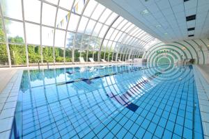 a large swimming pool with a glass ceiling at ANA Crowne Plaza Narita by IHG in Narita