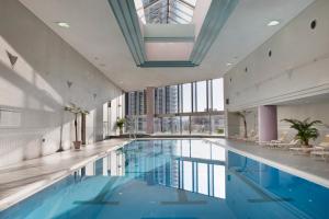 a swimming pool in a building with a ceiling at ANA Crowne Plaza Kobe, an IHG Hotel in Kobe