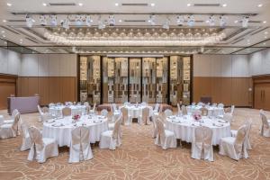 a banquet hall with white tables and chairs at ANA Crowne Plaza Kanazawa by IHG in Kanazawa