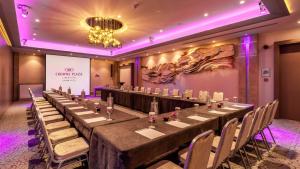 a long table in a room with purple lighting at Crowne Plaza Limassol by IHG in Limassol