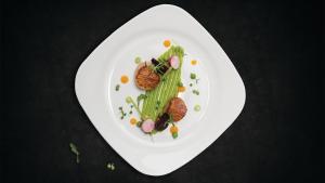 a plate of food with vegetables on a table at Crowne Plaza Limassol by IHG in Limassol