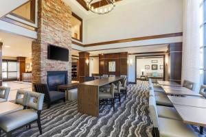 a conference room with tables and chairs and a fireplace at Staybridge Suites Reno Nevada, an IHG Hotel in Reno