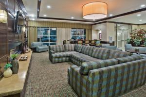 a living room filled with furniture and a large window at Crowne Plaza Anchorage-Midtown, an IHG Hotel in Anchorage