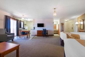 a large hotel room with two beds and a desk at Quality Inn & Suites Crescent City Redwood Coast in Crescent City