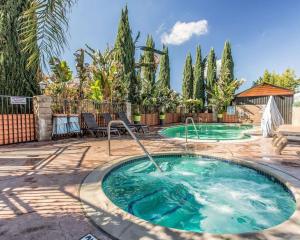 a hot tub in a yard with trees at Quality Inn Hemet - San Jacinto in Hemet