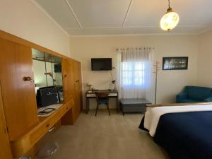 a hotel room with a bed and a desk with a computer at Hideaway on Hume in Boonah
