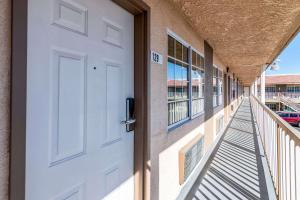 a door is open to a hallway with a view of a building at Rodeway Inn On Historic Route 66 in Barstow