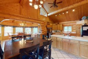 a kitchen and dining room with a large wooden table at Sunflower Lodge in Pagosa Springs