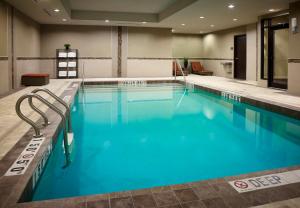 a large pool with blue water in a hotel room at Staybridge Suites Hamilton - Downtown by IHG in Hamilton