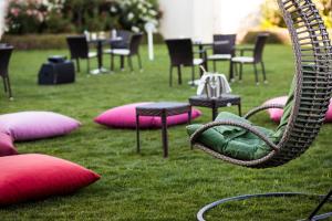 a swing in the grass with chairs and tables at Crowne Plaza Istanbul Oryapark by IHG in Istanbul