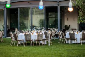 a group of tables and chairs on the grass at Crowne Plaza Istanbul Oryapark by IHG in Istanbul