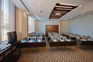 a conference room with tables and chairs and a television at Crowne Plaza Istanbul Oryapark by IHG in Istanbul