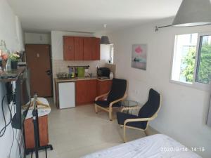 a kitchen with two chairs and a table at Amir's Apartments in Tel Aviv