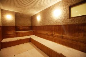 a sauna with wood paneling and a mirror and lights at ANA Crowne Plaza Hotel Kyoto by IHG in Kyoto