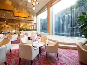 a restaurant with white chairs and tables and a large window at ANA Crowne Plaza Hotel Kyoto by IHG in Kyoto
