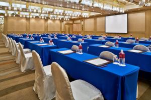 a conference room with blue tables and chairs and a screen at ANA Crowne Plaza Hotel Kyoto by IHG in Kyoto
