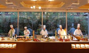 a group of chefs in a kitchen preparing food at ANA Crowne Plaza Hotel Kyoto by IHG in Kyoto