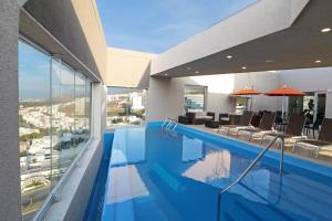 a swimming pool with a view of a building at Staybridge Suites San Luis Potosi by IHG in San Luis Potosí