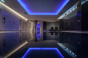 a swimming pool with a blue lighting in a room at Crowne Plaza Newcastle - Stephenson Quarter, an IHG Hotel in Newcastle upon Tyne