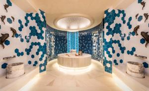 a bathroom with blue and white walls and a round tub at Crowne Plaza Florya Istanbul by IHG in Istanbul