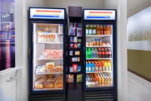 a refrigerator filled with lots of different types of drinks at Staybridge Suites - Miami International Airport by IHG in Miami