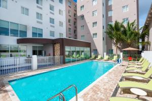 an image of a swimming pool at a hotel with lounge chairs at Staybridge Suites - Miami International Airport by IHG in Miami