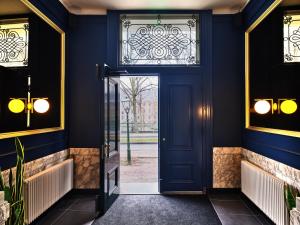 a blue door in a building with a window at Staybridge Suites The Hague - Parliament, an IHG Hotel in The Hague