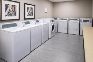 a laundry room with white washers and dryers at Staybridge Suites - Pecos by IHG in Pecos