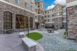 a courtyard with tables and benches in front of a building at Staybridge Suites Anchorage, an IHG Hotel in Anchorage