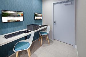 a room with a desk with a computer and two chairs at Holiday Inn Express Hollywood Walk of Fame by IHG in Los Angeles