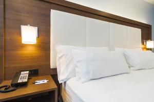 a hotel room with a bed and a phone on a table at Holiday Inn Express Hollywood Walk of Fame by IHG in Los Angeles