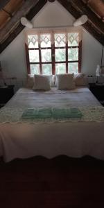 a large bed in a room with a window at Las chozas in Punta del Este