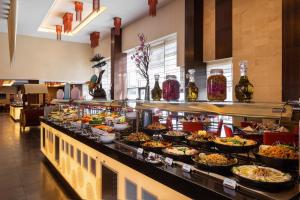 a buffet line with many different types of food at Crowne Plaza Riyadh - RDC Hotel & Convention by IHG in Riyadh