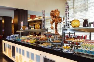 a buffet line with a lot of food on display at Crowne Plaza Riyadh - RDC Hotel & Convention by IHG in Riyadh +70 photos