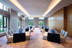 a row of tables and chairs in a room with windows at Crowne Plaza Huzhou by IHG in Huzhou +214 photos