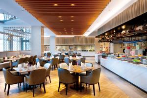 a restaurant with tables and chairs and a bar at Crowne Plaza Huzhou by IHG in Huzhou