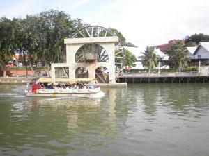 a group of people on a boat in the water at Vinz Hotel in Melaka