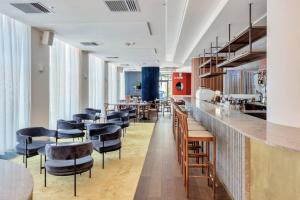 a bar in a restaurant with chairs and tables at Urban Deco Apartment on Queen Street in Auckland