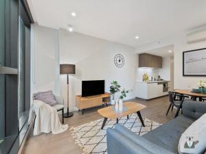 una sala de estar con un sofá y una mesa en KOZYGURU MELBOURNE CITY PERFECT TRANQUIL SANCTUARY 1 BED APT VME023, en Melbourne