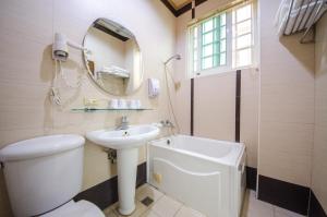 a bathroom with a toilet and a sink and a mirror at 太平山-部落山莊景觀民宿 in Datong +120 photos