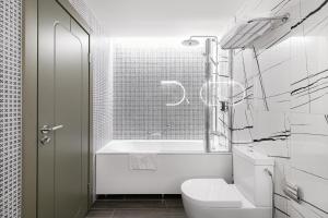 a bathroom with a toilet and a bath tub at Kaunas in Kaunas