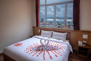 A bed or beds in a room at UCT Taunggyi Hotel