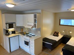 a small kitchen with a dog laying on a bed at VASA Apartments in Rovaniemi +14 photos