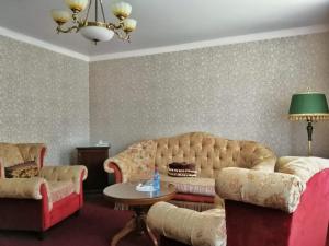 a living room with a couch and a table at GK Grand-Hotel in Kislovodsk
