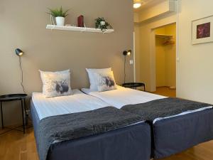 ロヴァニエミにあるホテル アーケヌス アパートメンツのベッドルーム1室(大型ベッド1台、青いシーツ、枕付)