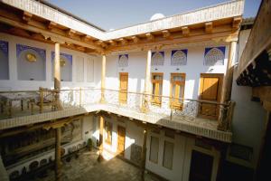 a view of a building with a balcony at Mukhlisabegim Hotel in Bukhara