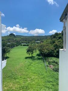 a view from the balcony of a house with trees in a field at 35.5 Inn in Kenting
