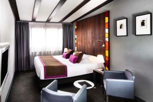 Hotel Le Colombier في أوبرناي: غرفه فندقيه بسرير وكرسي