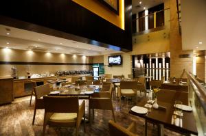 a restaurant with tables and chairs and a bar at Hotel Private Affair (A Boutique Hotel) in New Delhi