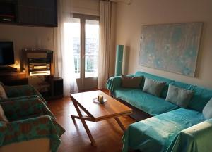 a living room with a couch and a coffee table at Lilioum Apartment in Thessaloniki